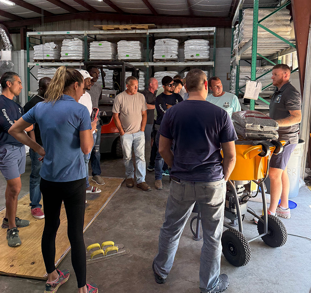 Resin Rock hands-on installer training session in warehouse with mixing equipment